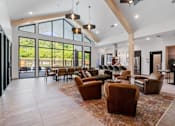 Thumbnail 24 of 76 - A living room with a glass wall and brown leather chairs.