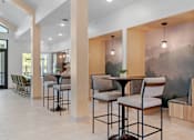 Thumbnail 26 of 76 - A modern dining area with a table surrounded by chairs.