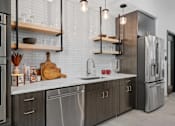 Thumbnail 34 of 76 - A modern kitchen with stainless steel appliances and wooden accents.