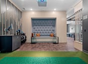 Thumbnail 42 of 76 - A modern waiting room with a bench and luggage.