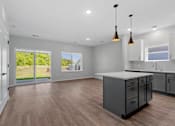 Thumbnail 56 of 76 - A kitchen with a large island and a view of the backyard.