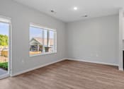 Thumbnail 63 of 76 - A room with a large window and a wooden floor.