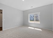Thumbnail 64 of 76 - A room with a window showing a view of a building outside.