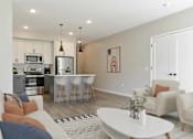 Thumbnail 71 of 76 - A modern kitchen with a breakfast bar and a living room with a couch and chairs.