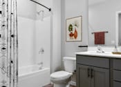 Thumbnail 75 of 76 - A bathroom with a toilet, sink, and shower.