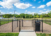 Thumbnail 28 of 32 - A black fence surrounds a playground with a metal gate.