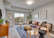 Thumbnail 2 of 32 - Living room with balcony at The Westlyn apartments for rent in St. Paul, MN