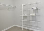 Thumbnail 10 of 30 - A white shelving unit with boxes on top of it.