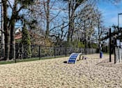 Thumbnail 25 of 30 - A playground with a slide and a fence.