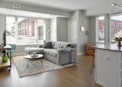 Thumbnail 4 of 30 - Spacious living room with grey couch at Park 205 Apartments in Park Ridge, IL