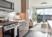 Thumbnail 4 of 43 - Modern kitchen with stainless steel appliances at The Bohen apartments in Uptown Minneapolis, MN.