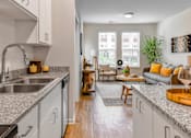 Thumbnail 5 of 42 - A modern kitchen with a dining area in the background.