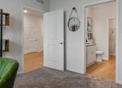 Thumbnail 18 of 42 - A white door is open to a bathroom.