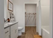 Thumbnail 17 of 42 - A bathroom with a toilet, sink, and bathtub.