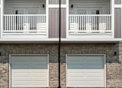 Thumbnail 19 of 42 - A building with two garage doors and a balcony.