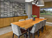 Thumbnail 27 of 42 - A modern dining room with a wooden table and grey chairs.