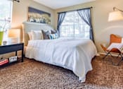 Thumbnail 7 of 43 - Spacious model bedroom with neutral décor at Riverset Apartments in Memphis, TN.