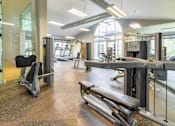 Thumbnail 35 of 43 - A gym with a variety of equipment including a leg press machine.