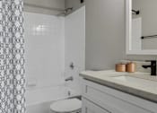 Thumbnail 21 of 43 - Bright and open bathroom with shower, tub and sink at Riverset Apartments waterfront apartments in Memphis, TN.