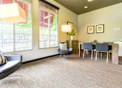 Thumbnail 38 of 43 - A waiting room with a chair, a table, and a lamp.