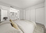 Thumbnail 5 of 27 - A bedroom with a bed, a dresser, and a mirror.