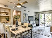Thumbnail 8 of 27 - A dining room with a table set for four.