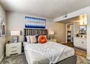 Thumbnail 11 of 27 - A bedroom with a large bed and a painting on the wall.