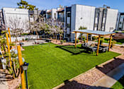 Thumbnail 25 of 27 - A sunny day at a modern building with a green lawn and a pavilion.