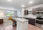 Thumbnail 3 of 36 - Well-appointed kitchen with granite countertops, island and stainless steel appliances
