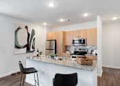 Thumbnail 2 of 36 - Well-appointed kitchen with island and granite countertops