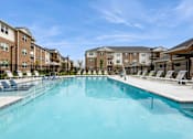 Thumbnail 23 of 36 - Expansive swimming pool in front of apartment buildings