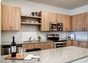Thumbnail 5 of 36 - A modern kitchen with stainless steel appliances and wood cabinets