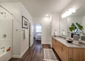 Thumbnail 6 of 36 - Elegant bathroom with dual sinks and under-the-counter storage