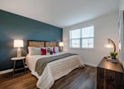 Thumbnail 21 of 36 - Spacious bedroom with bright windows and plank flooring