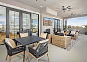 Thumbnail 3 of 20 - A modern patio with a table and chairs.