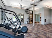 Thumbnail 36 of 50 - A gym with treadmills and exercise equipment.