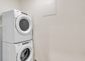 Thumbnail 25 of 50 - Two white front load washing machines stacked on top of each other.