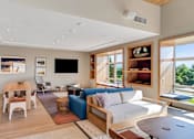 Thumbnail 34 of 50 - A modern living room with a wooden floor and furniture.