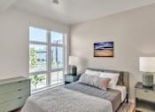Thumbnail 15 of 50 - A bedroom with a large bed and a painting on the wall.
