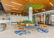 Thumbnail 1 of 48 - A modern living room with a green plant on the ceiling.