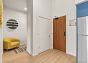 Thumbnail 40 of 48 - A yellow chair sits in a room with a white door and a wooden door.