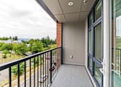 Thumbnail 25 of 48 - A balcony with a black railing and a view of the outdoors.