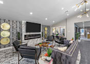 Thumbnail 8 of 26 - A modern living room with a grey sofa, a coffee table, and a fireplace.