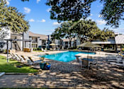 Thumbnail 15 of 26 - A backyard with a pool and patio furniture.
