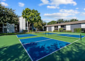 Thumbnail 20 of 26 - A tennis court with blue and green surface and white lines.