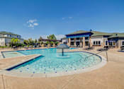 Thumbnail 22 of 33 - A large outdoor swimming pool with a fountain in the middle.