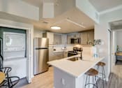 Thumbnail 1 of 33 - A modern kitchen with stainless steel appliances and a central island.