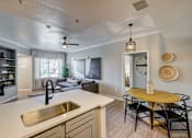 Thumbnail 3 of 33 - A modern kitchen with a dining table and chairs.