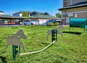 Thumbnail 31 of 33 - A playground with a horse-shaped swing set in the foreground.