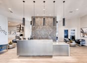 Thumbnail 17 of 33 - A reception area with a large desk and a wall with a black and white pattern.